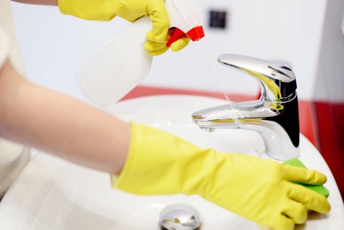 Office cleaning team sanitising desks and shared surfaces in Hampstead