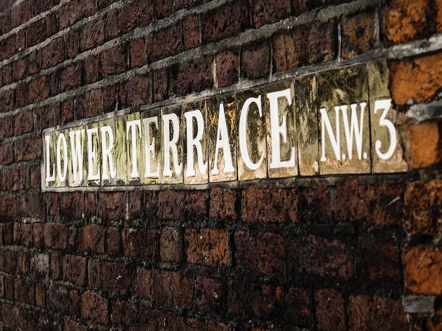 Image of The Printing Wall Building, a historic brick structure with large arched windows on the ground floor and smaller rectangular windows on the upper level. The building has a weathered appearanc